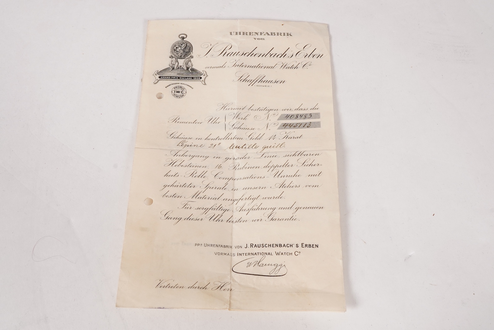 An early 20th century International Watch Company engine turned 14k yellow metal open faced keyless lever pocket watch, together with a Viennese? two colour yellow metal albert, maker's mark, LE